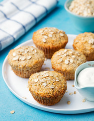 Healthy vegan oat muffins, apple and banana cakes with sour cream on a white plate