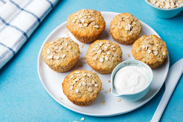 Healthy vegan oat muffins, apple and banana cakes with sour cream on a white plate