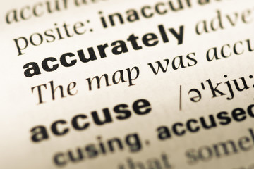 Obraz premium Close up of old English dictionary page with word accurately