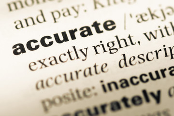 Close up of old English dictionary page with word accurate