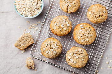 Healthy vegan oat muffins, apple and banana cakes on a cooling rack Top view Copy space