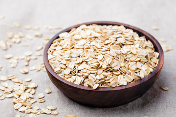 Healthy breakfast Organic oat flakes in a wooden bowl