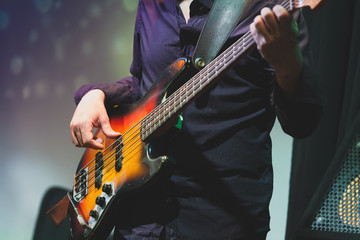 Rock and roll music, bass guitar player closeup