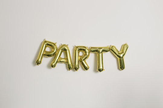 Word party in gold inflatable capital letters