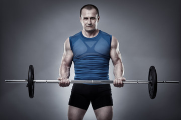 Man doing biceps curl with barbell