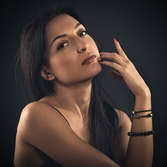 Portrait of a beautiful young woman on a black background
