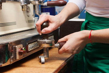 woman presses the coffee