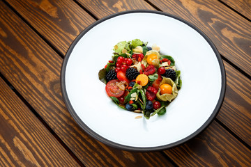 Summer salad with nut mass and seasonal berries selected focus