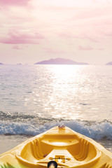Fototapeta na wymiar Kayak prow on tropical beach in sunset, pastel vintage tone
