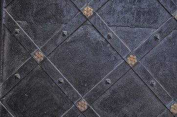 Vintage and ornamental metal door background. Decorated ancient texture with rhombs. 