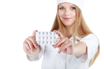 A beautiful young nurse offering pills