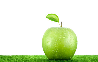 Green apple on the grass with isolated background