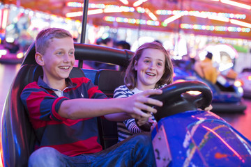 Brother and sister on fairground bumper cars