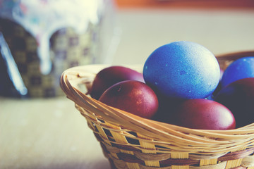 Painted colorful easter eggs close up and easter cake. Selective focus on eggs. Image with vintage filter
