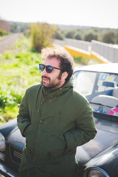 Mid adult man in front of vintage car