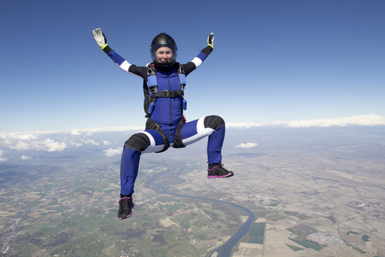 Freeflying skydiver in blue sky