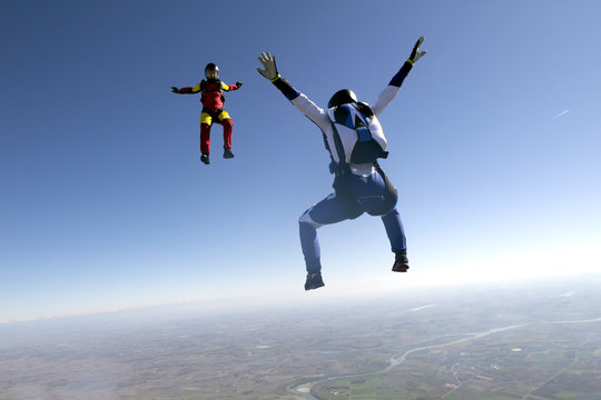 Freeflying skydivers in blue sky