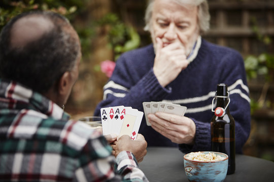 Two senior men playing cards