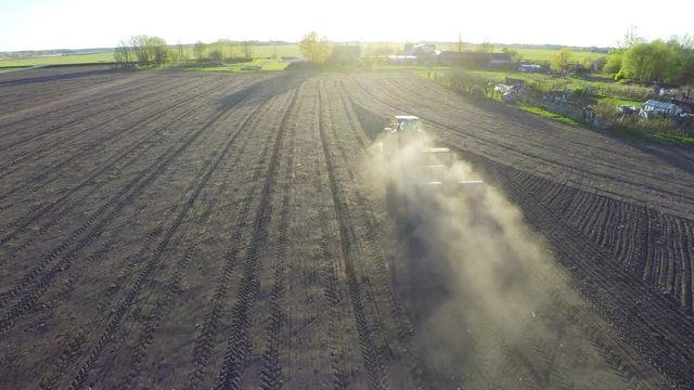 Agriculture, Tractor Working On A Field. Aerial footage.
