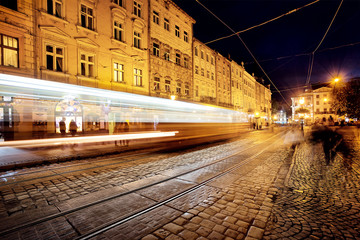 Street with tramway rails and tracks from headlights