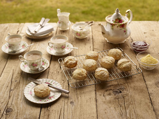 Table with afternoon tea of with fresh baked scones with jam and clotted cream