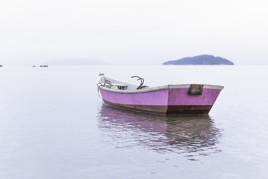 Anchored pink rowing boat, Manguinhos, Buzios, Rio de Janeiro, Brazil