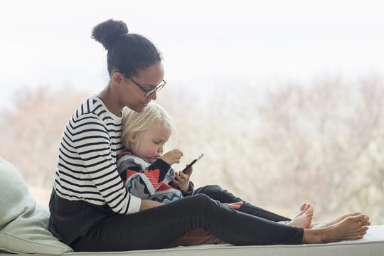 Mother and son sitting together using tablet