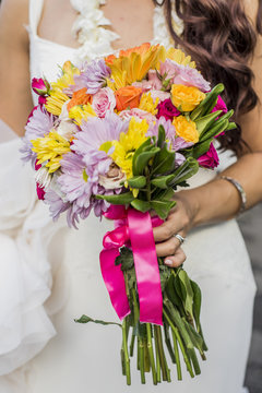Cropped view of bride and colorful bouquet at Hawaiian wedding, Kaaawa, Oahu, Hawaii, USA
