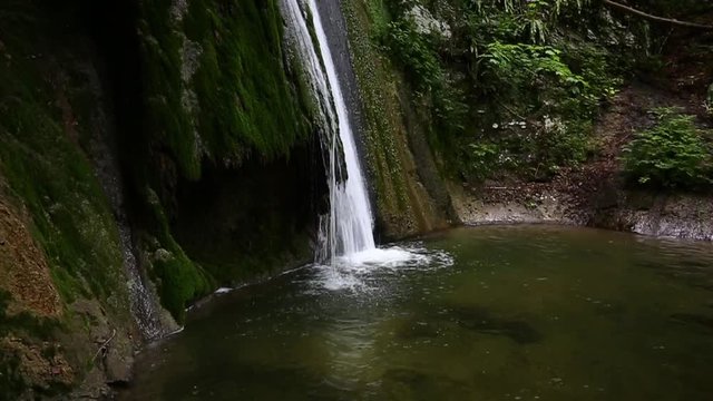 Waterfall in the mountain forest, slow motion