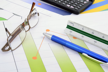 Business still life with pen, glasses and calculator ..