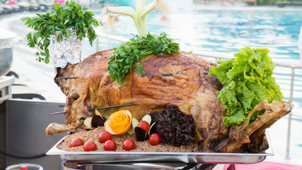Whole roasted lamb with vegetables