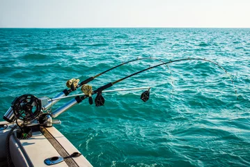 Fotobehang Two Fishing Poles Mounted on a Boat © Pvstockmedia