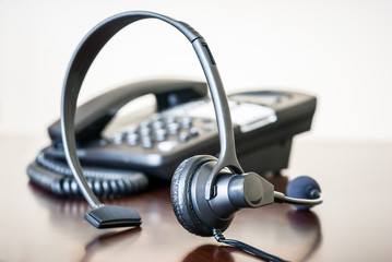 Obraz na płótnie Canvas Headset and Business Telephone on a Desk