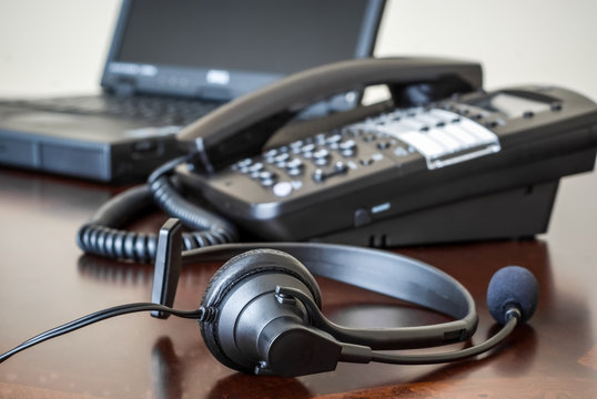 Headset, Telephone and Laptop on a Desk