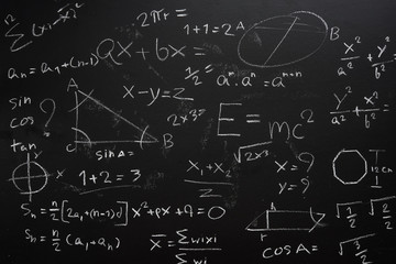 Teacher Hand drawn mathematics on chalkboard.