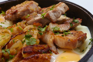 fried meat with potatoes and egg