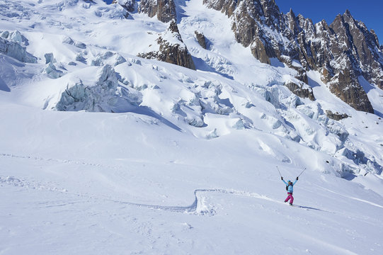 Mature female skier celebrating on Mont Blanc massif, Graian Alps, France