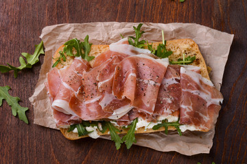 Ham sandwich on wooden table