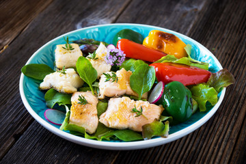 Fish fillets with vegetables on wooden background