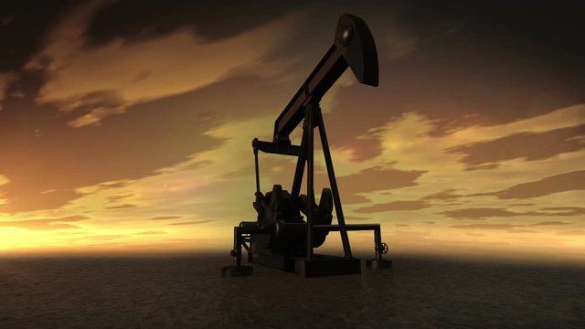 Oil industry pump. Oil donkeys producing crude oil in a desert location at sunset