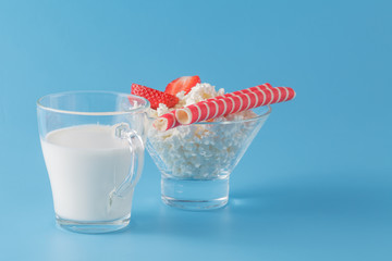 glass of milk and wafer cookies on blue