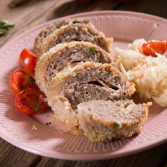 Meat roll stuffed with cheese and ham