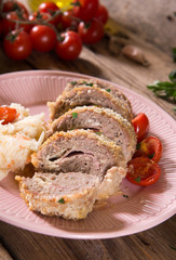Meat roll stuffed with cheese and ham