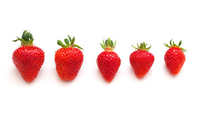 Strawberries different size isolated on white background