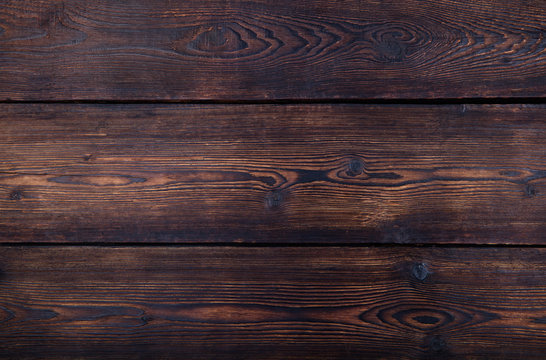Dark brown wooden background with high resolution. Top view Copy space.