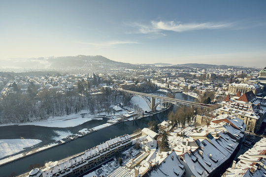 High angle view of river Aare and city with snow covered rooftops, Berne, Switzerland