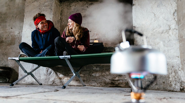 Young couple hiking, in shelter for rest, Honister Slate Mine, Keswick, Lake District, Cumbria, United Kingdom