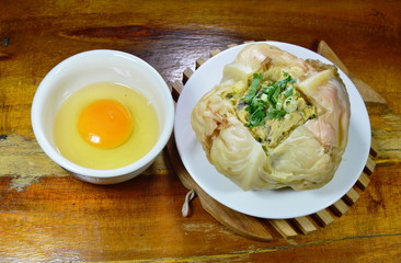 steamed egg with mushroom in cabbage and yolk on cup