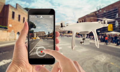 Smart phone control drone with app. City street in background.
