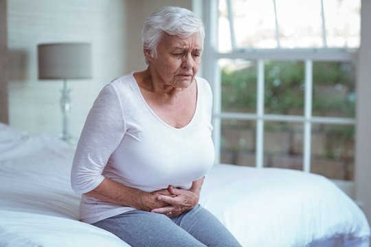 Senior woman suffering from stomach pain